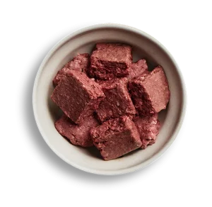 Bowl of raw dog food chunks from We Feed Raw